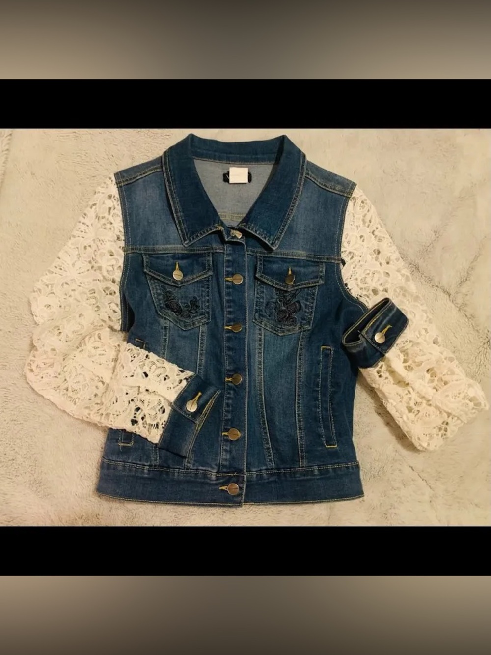 Venus brand denim vest features distinct white lace sleeves and floral